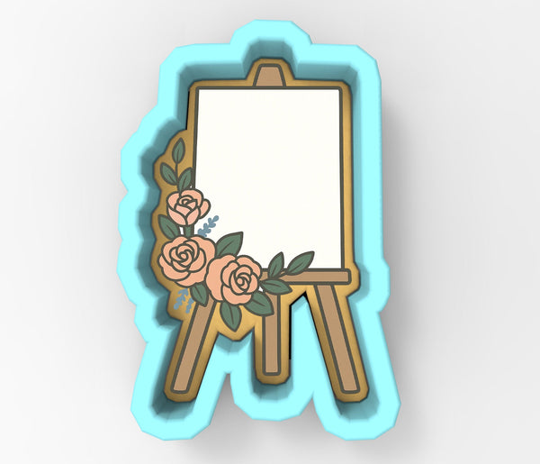 A 3D rendering of a white canvas on a wooden easel, decorated with pink roses and green leaves.