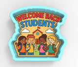 A group of children, including a boy and a girl, are standing in front of a school building, with a sign that says "Welcome Back Students".
