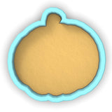 a cookie cutter with a cookie in the shape of a pumpkin