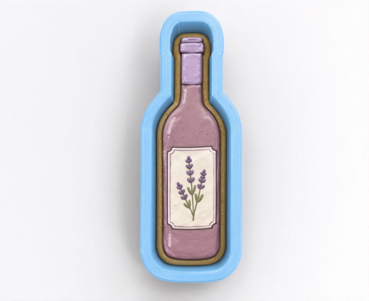 A cookie cutter shaped like a wine bottle with a label featuring lavender flowers.
