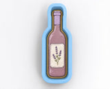 A cookie cutter shaped like a wine bottle with a label featuring lavender flowers.