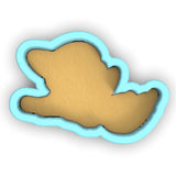 a cookie shaped like a bird flying through the air