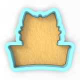 a cookie cutter with a cookie in the shape of a cat