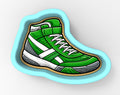 A green and white sneaker-shaped cookie cutter.