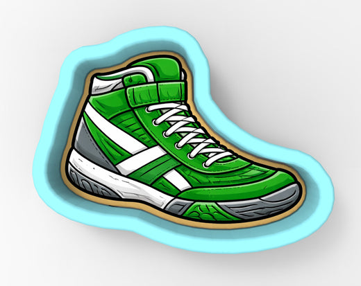 A green and white sneaker-shaped cookie cutter.