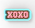 A blue cookie cutter with the word "XOXO" printed on it, surrounded by red heart shapes.