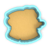 a cookie cutter with a cookie in the shape of a face